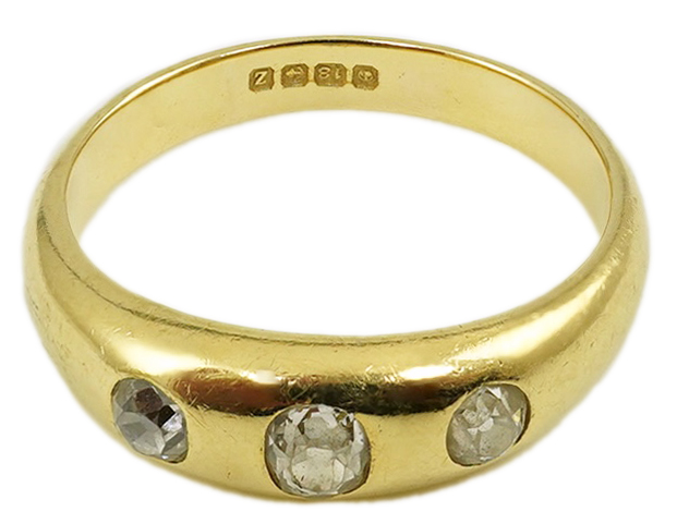 A George V 18ct gold and three stone gypsy set diamond ring